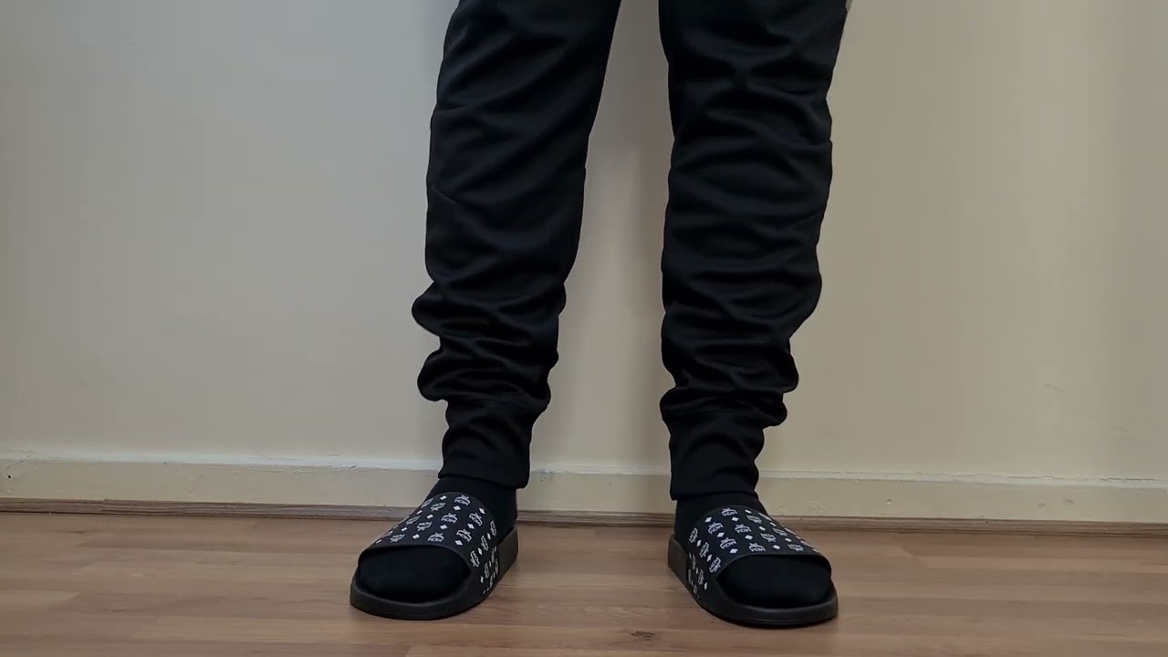 MCM VISETOS RUBBER SLIDES BLACK WHITE ON FOOT