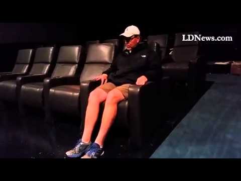 Paul Wenger, vice president of Flagship Cinemas, demonstrates how to use one of the electric reclin