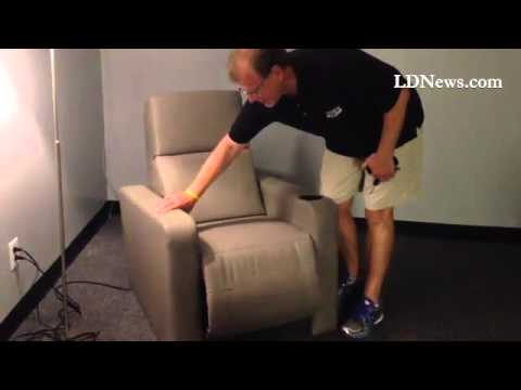 Paul Wenger, VP of Flagship Cinemas, demonstrates the chairs that will be installed in their Palmyra
