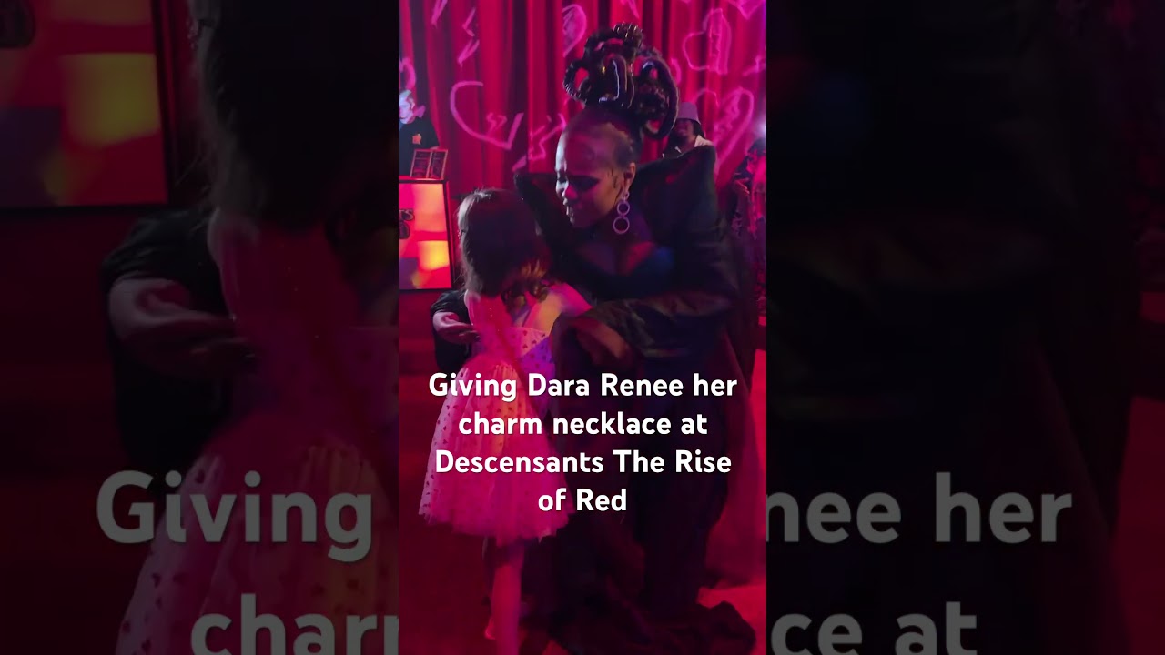 Giving Dara Renee a charm necklace at Descendants The Rise Of Red Premiere
